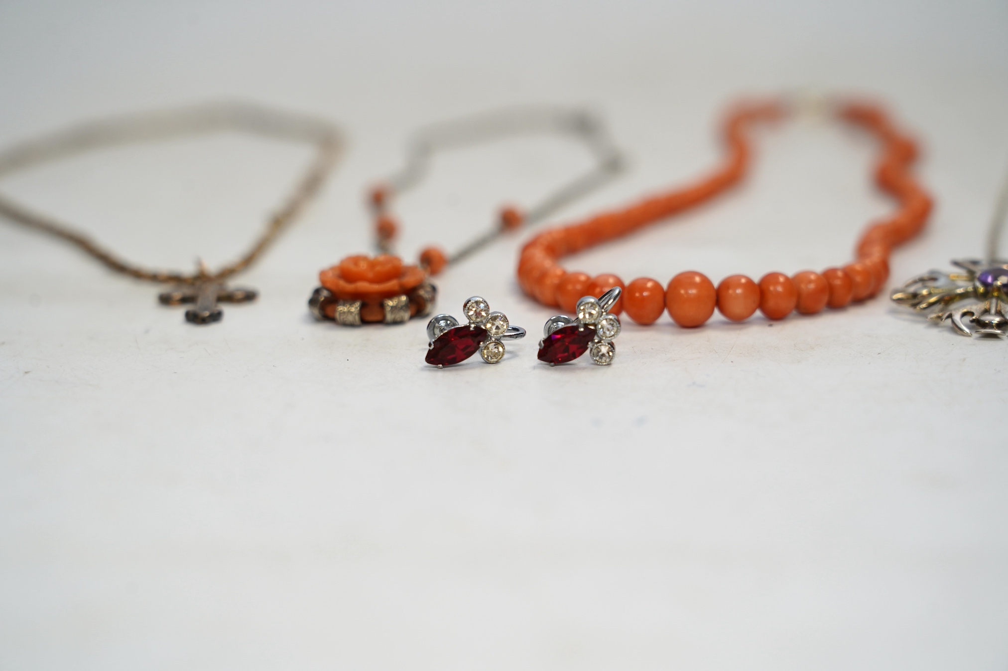 A Victorian yellow metal crucifix on a yellow metal chain, a coral necklace and other assorted jewellery. Condition - fair to poor